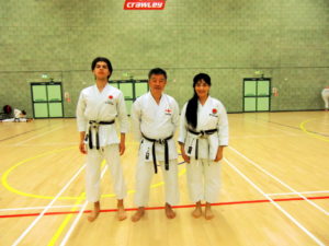 (Click to Enlarge) Sensei Shahinaz Pelter (3rd Dan), Sensei Patrick (2nd Dan) with JKA England Chief Instructor Sensei Ohta (7th Dan)