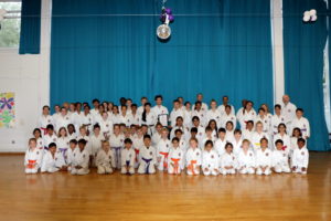 (Click to Enlarge) Bromley & South East London JKA Karate Club Receiving a New Award at the Club’s Summer Grading . Sensei Ohta, 7th Dan, JKA England Chief Instructor, Sensei Shahinaz Pelter & Sensei Patrick Pelter with some of the club members at the dojo , on Friday 19th July 2019. 
